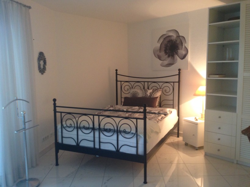 A full size bed, in the main living area